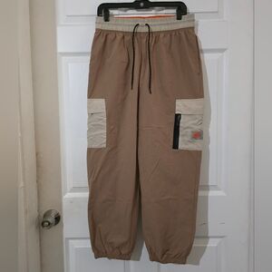 Nike Medium Sportswear Women's Woven Cargo Pants in a beige color Drifwood.